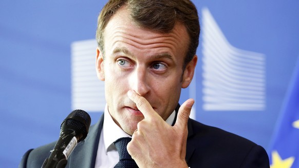 epa06837281 French President Emmanuel Macron speaks to media after the informal meeting on migration and asylum issues in Brussels, Belgium, 24 June 2018. European Commission President Jean-Claude Jun ...