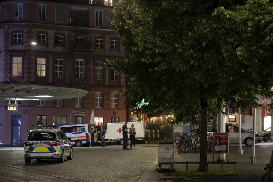 Emergency vehicles stand near the scene of the crime on Barbarossaplatz in the city centre of Wuerzburg, Germany, Friday, June 25, 2021. Authorities say a man armed with a long knife killed several pe ...