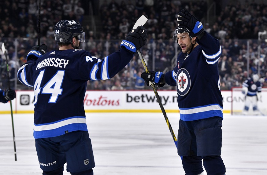 Winnipeg Jets&#039; Nino Niederreiter celebrates his goal against the San Jose Sharks with teammate Josh Morrissey during the second period of an NHL hockey game, in Winnipeg, Manitoba, on Monday Marc ...