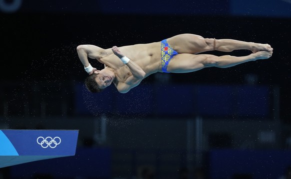 Yang Jian of China competes in men&#039;s diving 10m platform preliminary at the Tokyo Aquatics Centre at the 2020 Summer Olympics, Friday, Aug. 6, 2021, in Tokyo, Japan. (AP Photo/Dmitri Lovetsky)