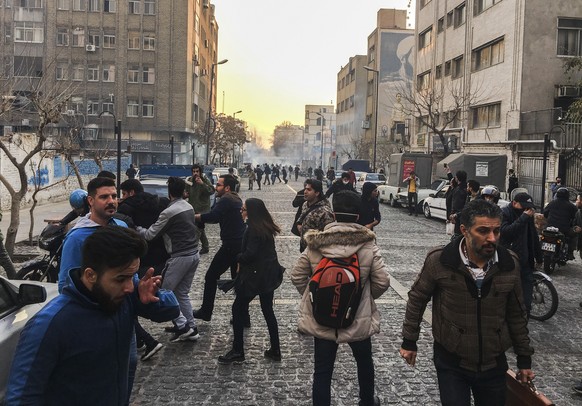 In this photo taken by an individual not employed by the Associated Press and obtained by the AP outside of Iran, people are affected by tear gas fired by anti-riot Iranian police to disperse demonstr ...