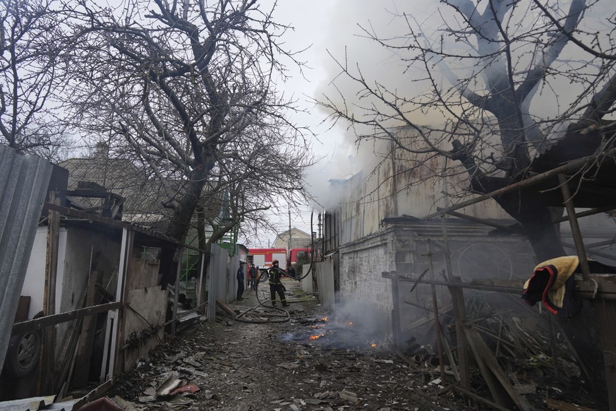 A firefighter works amongst debris in the aftermath of Russian shelling, in Mariupol, Ukraine, Thursday, Feb. 24, 2022. Russia has launched a barrage of air and missile strikes on Ukraine early Thursd ...