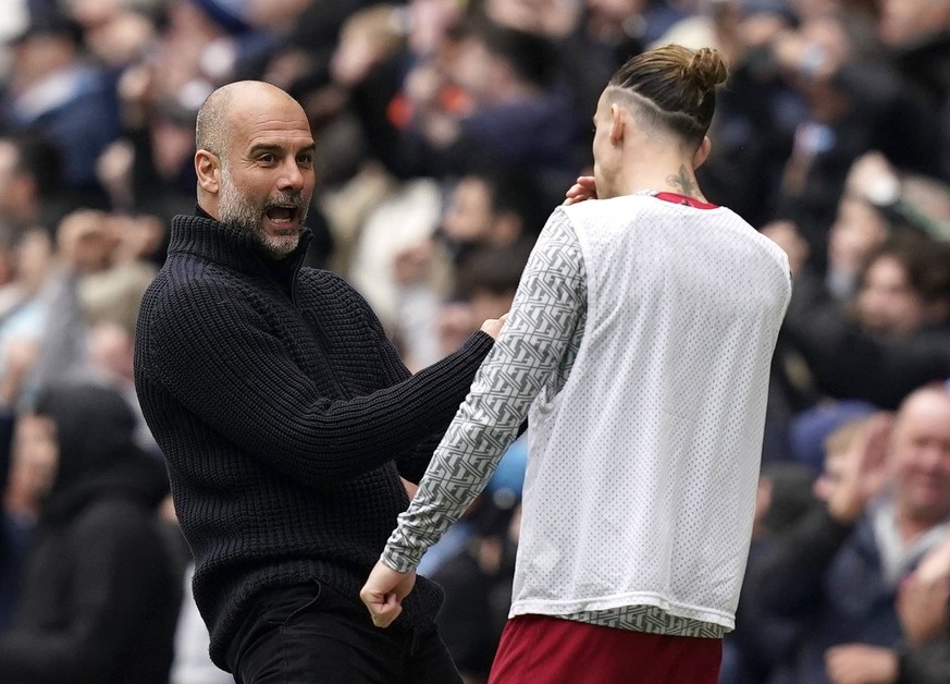 Manchester, England, 1st April 2023. Josep Guardiola manager of Manchester City L celebrates his sides first goal in front of Kostas Tsimikas of Liverpool during the Premier League match at the Etihad ...