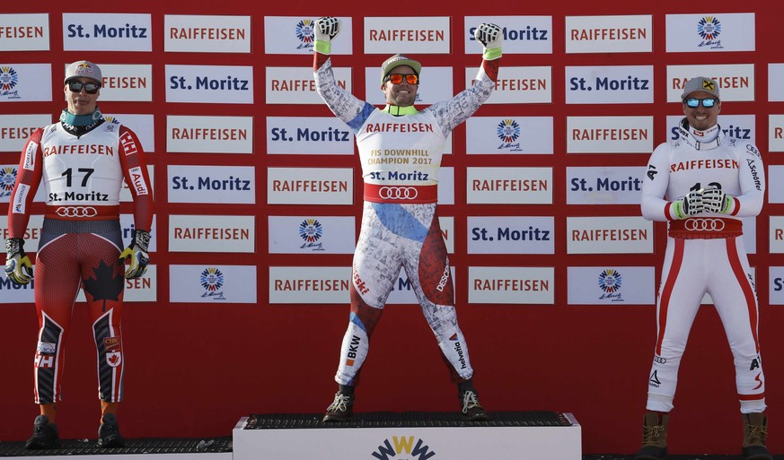 Alpine Skiing - FIS Alpine Skiing World Championships - Men&#039;s Downhill - St. Moritz, Switzerland - 12/2/17 - Gold medalist Beat Feuz of Switzerland is flanked by Canada&#039;s silver medalist Eri ...