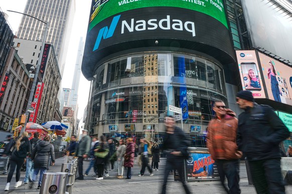 People pass the Nasdaq MarketSite in New York's Times Square, Friday, Nov. 7, 2025. (AP Photo/Richard Drew)
Financial Markets Wall Street