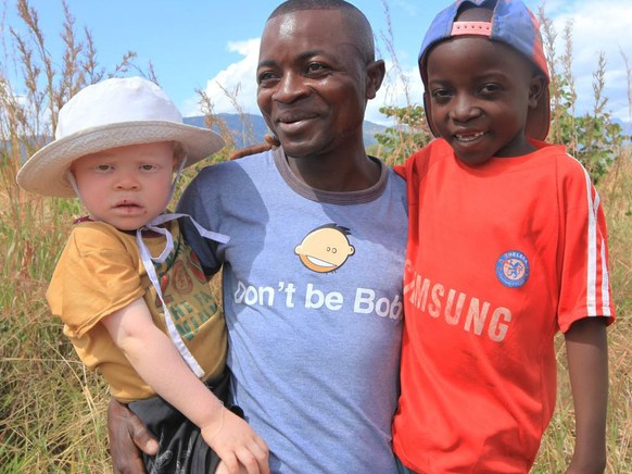 Razik Jaffalie carrys his two sons in this Monday, May, 23, 2016 photo in Machinga about 200 kilometres north east of Blantyre Malawi. Jaffalie gave up his work as a bicycle taxi operator to protect h ...