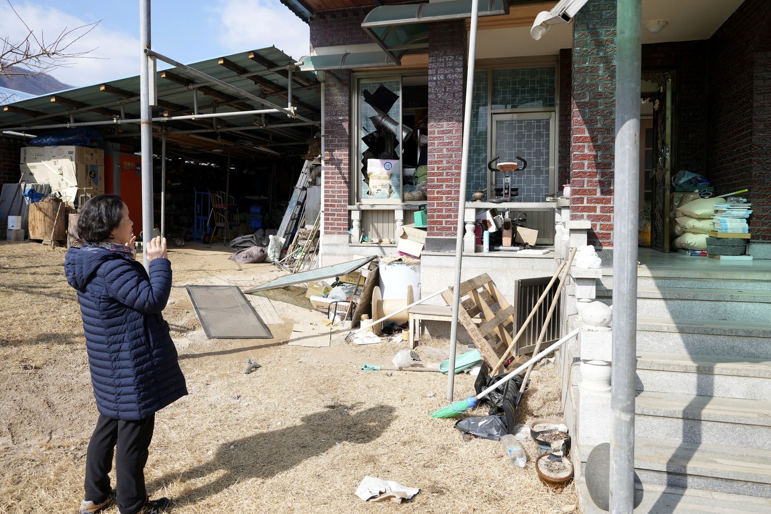 Local resident Park Sung-sook reacts at her damaged house near a bomb accident site in Pocheon, South Korea, Thursday, March 6, 2025. (AP Photo/Lee Jin-man)
South Korea Accidental Bombing