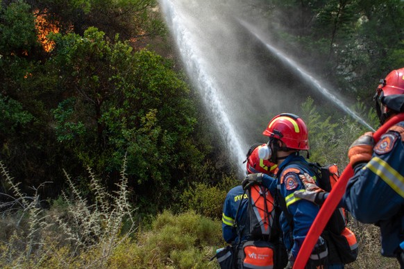 epa10769918 Firefighters operate during a wildfire in Vati village, on Rhodes island, Greece, 26 July 2023. The Fire Brigade forces are battling the rekindled fire fronts in the region of southern Rho ...