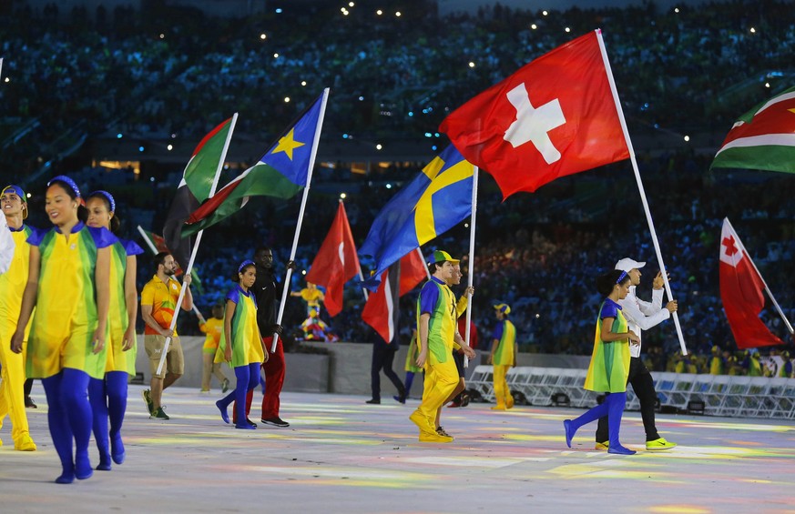 epa05506122 Flag bearer Nino Schurter (R) of Switzerland enters the Maracana Stadium during the Closing Ceremony of the Rio 2016 Olympic Games in Rio de Janeiro, Brazil, 21 August 2016. EPA/SERGEI ILN ...