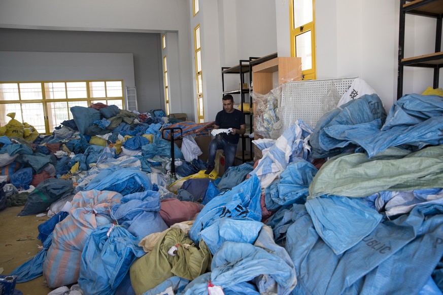 epa06952399 A Palestinian employee sorts undelivered mail at the Palestinian central international exchange post office in the West Bank city of Jericho, 16 August 2018. Earlier on the same week Israe ...