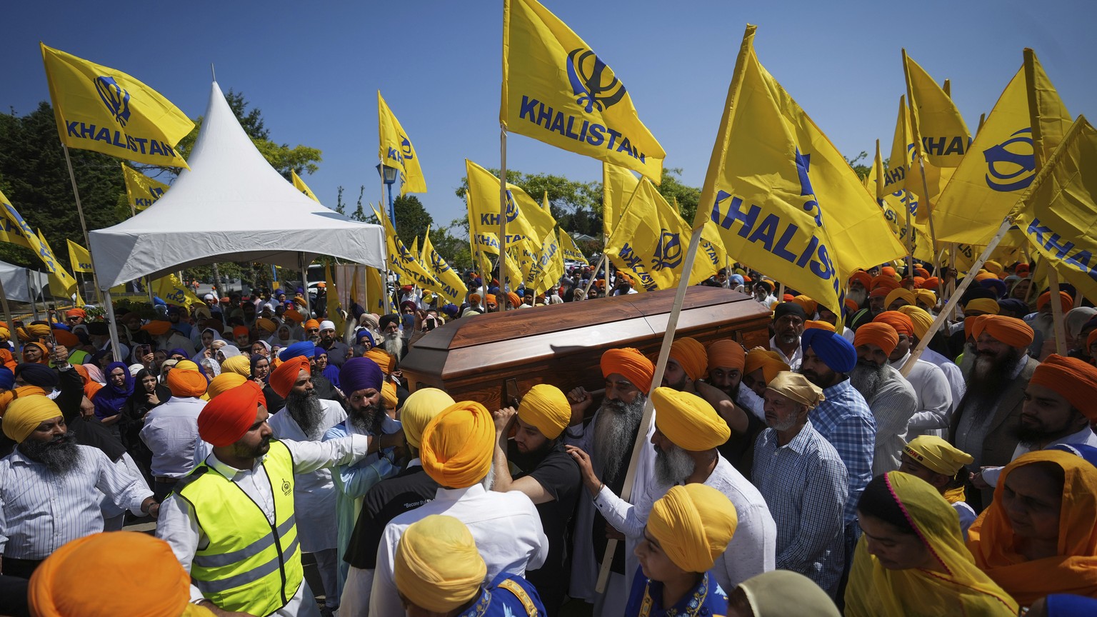 Mourners carry the casket of Sikh community leader and temple president Hardeep Singh Nijjar during Antim Darshan, the first part of a day-long funeral service for him, in Surrey, British Columbia, Su ...