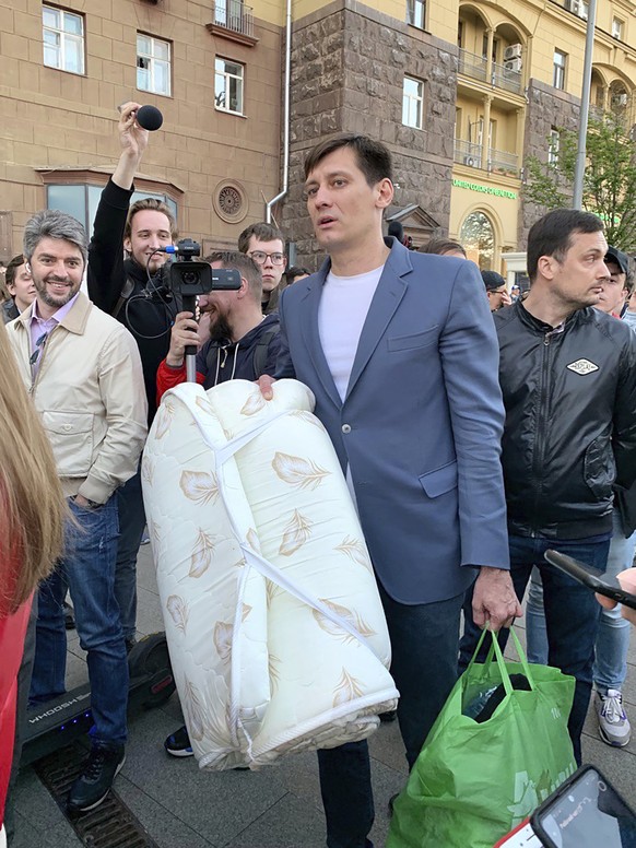 Dmitry Gudkov, center, a former Russian lawmaker who has aspired to run again for a parliament seat, is surrounded by people after being released in case of an expiration of 48 hours of detention in M ...