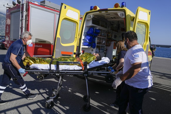 Paramedics transfer an injured survivor of a shipwreck to an ambulance at the port in Kalamata town, about 240 kilometers (150 miles) southwest of Athens, Wednesday, June 14, 2023. A fishing boat carr ...