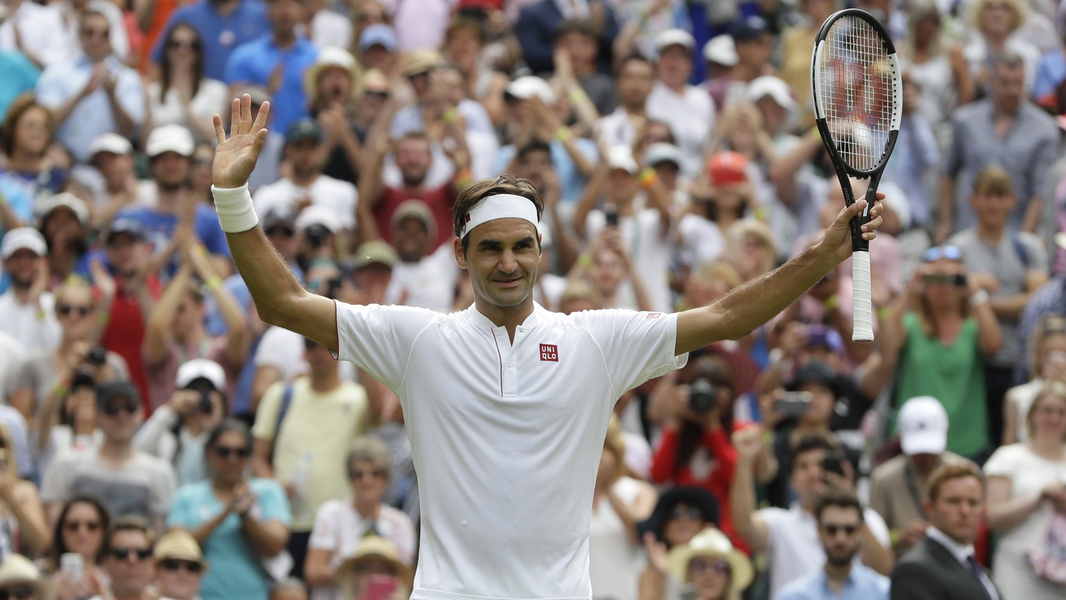 Switzerland&#039;s Roger Federer celebrates defeating Slovakia&#039;s Lukas Lacko in their men&#039;s singles match, on the third day of the Wimbledon Tennis Championships in London, Wednesday July 4, ...