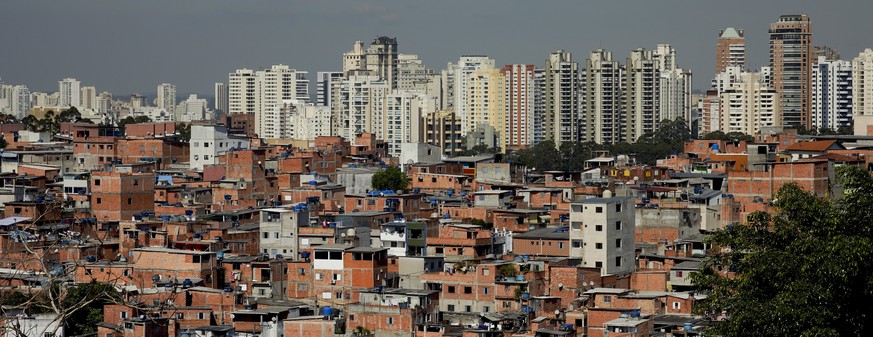 This May 22, 2019 photo shows brick and block brick houses of the sprawling slum neighborhood of Paraisopolis stacked next to the posh Morumbi neighborhood, in Sao Paulo, Brazil. A study released this ...