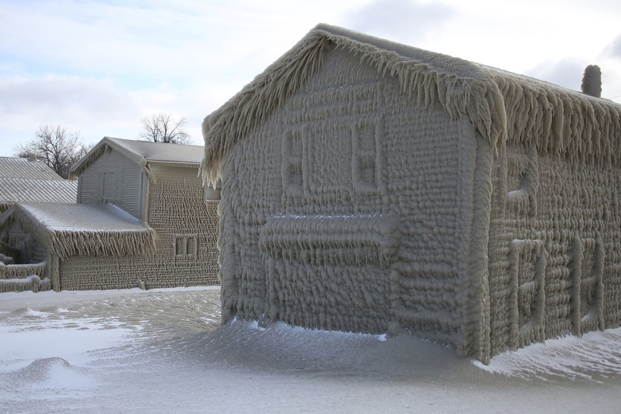 Houses along Hoover Beach is covered by ice from high winds and from the waves from Lake Erie, Saturday, Feb. 29, 2020, in Hamburg N.Y. Blowing snow has fallen around the state since Thursday, though  ...