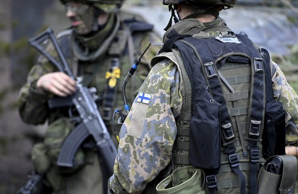 FILE - Finnish soldiers take part in the army's Arrow 22 mechanized exercise at the Niinisalo garrison in Kankaanp'', Western Finland, on May 4, 2022. Finland and Sweden have announced their int...