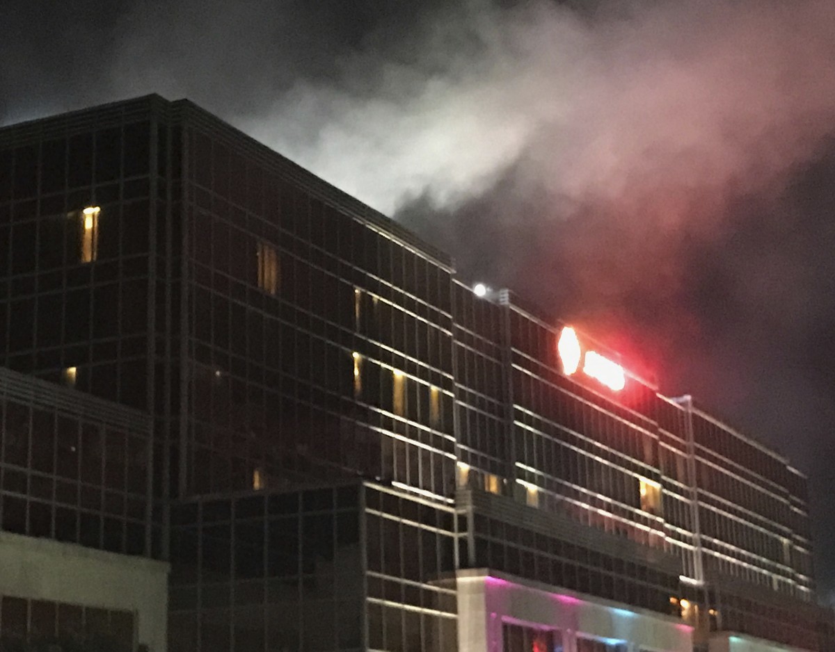 Smoke rises from the Resorts World Manila complex, early Friday, June 2, 2017, in Manila, Philippines. Gunshots and explosions rang out early Friday at a mall, casino and hotel complex near Manila ...