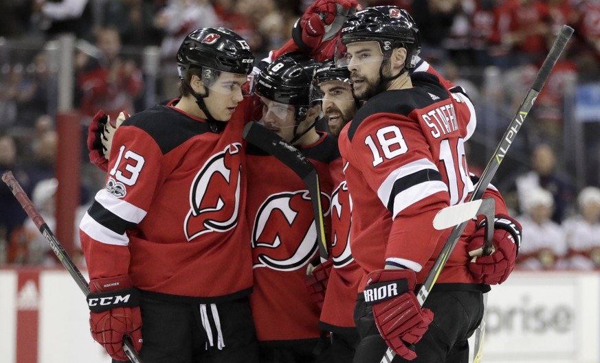 New Jersey Devils&#039; Nico Hischier (13), of Switzerland; Will Butcher; Kyle Palmieri; and Drew Stafford (18) celebrate Palmieri&#039;s goal against the Florida Panthers during the second period of  ...