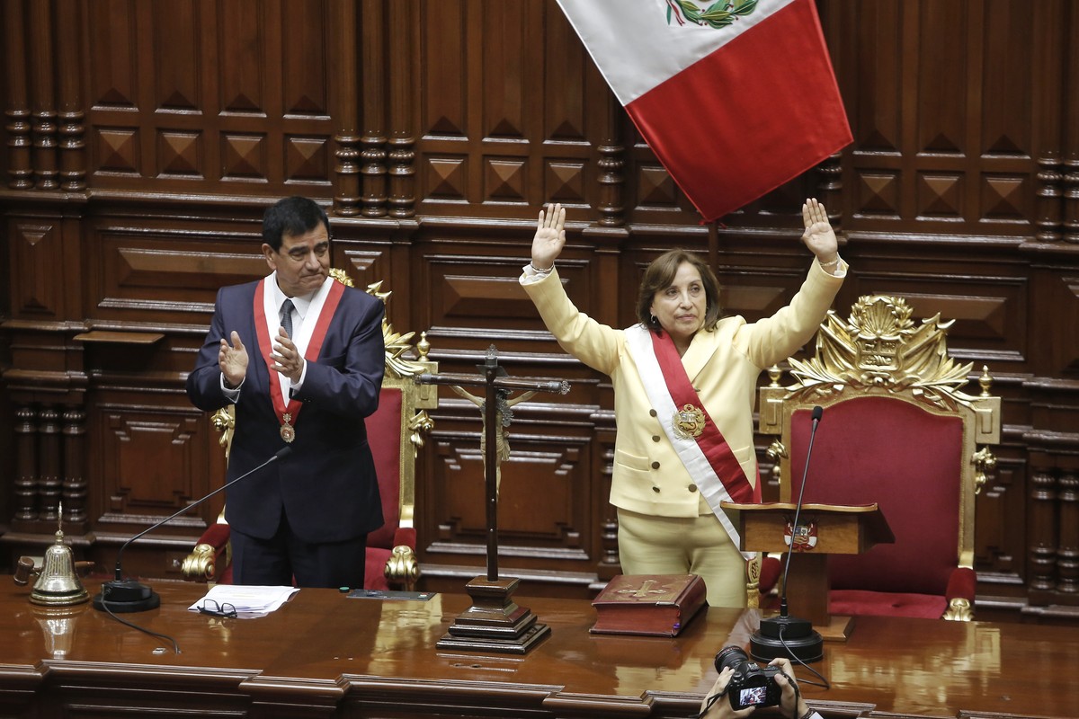 epa10354176 The lawyer Dina Boluarte waves after being sworn in as president by the president of Congress, Jose Daniel Williams Zapata (L), at the headquarters of Congress in Lima, Peru, 07 December 2 ...