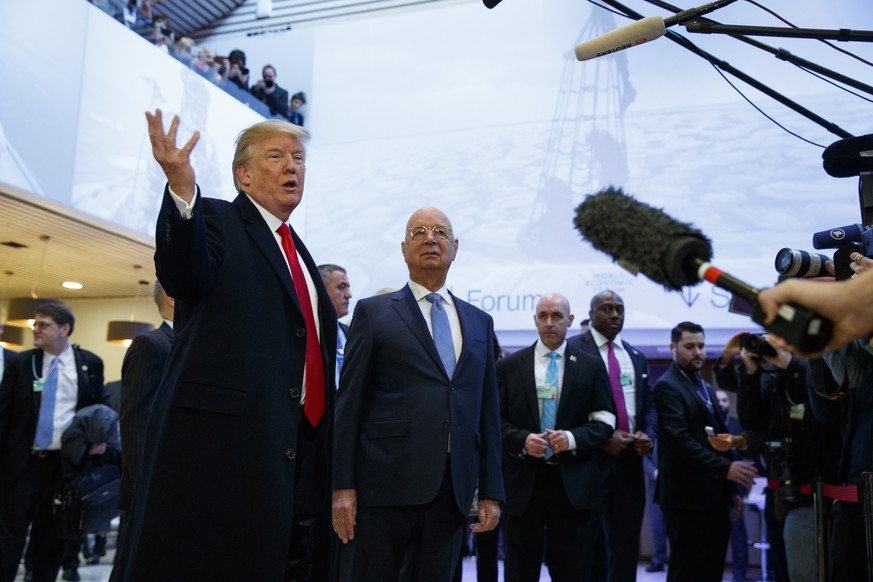 U.S. President Donald Trump talks with reporters as he arrives at the World Economic Forum, Friday, Jan. 26, 2018, in Davos, Switzerland. (AP Photo/Evan Vucci)