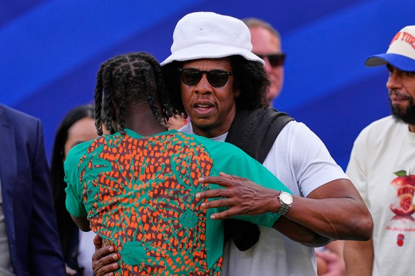 American rapper Jay-Z embraces Ivory Coast's Yan Diomande during the World Cup Group E soccer match between Ivory Coast and Ecuador in Philadelphia, Sunday, June 14, 2026. (AP Photo/Petr David Jo ...
