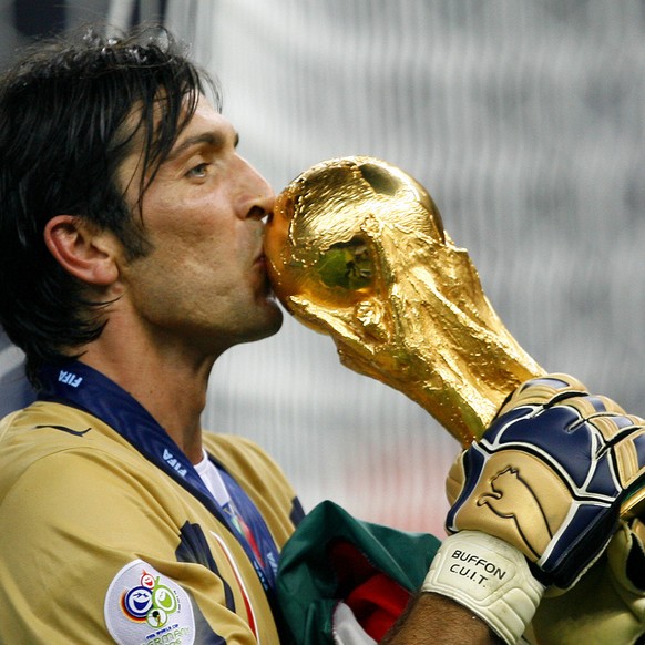 Italy's goal keeper Gianluigi Buffon kisses the World Cup trophy after the final of the soccer World Cup between Italy and France in the Olympic Stadium in Berlin, Sunday, July 9, 2006. Italy bea ...