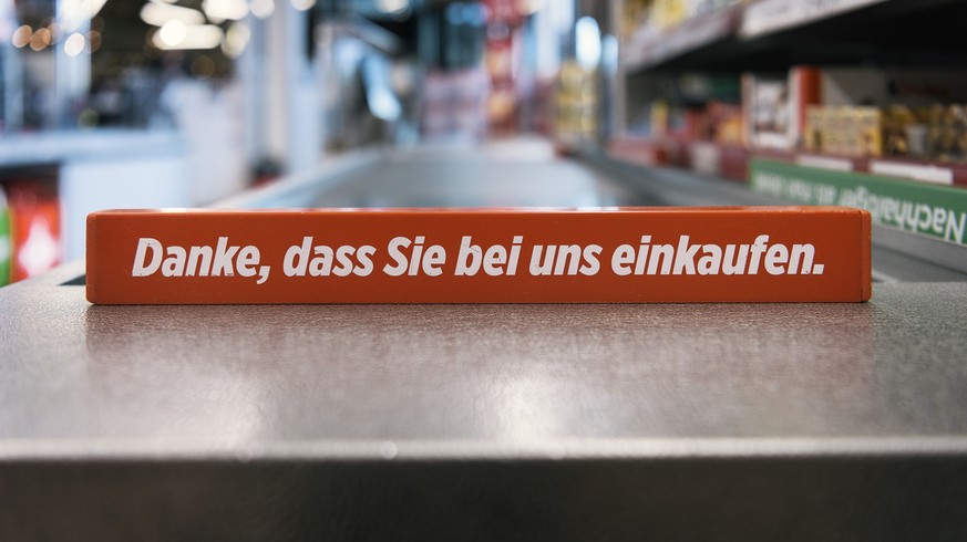 A checkout divider which reads &#039;Danke, dass Sie bei uns einkaufen&#039; (English: thank you for shopping with us) on a conveyor belt pictured in a branch of retailer Denner in Rueschlikon, canton ...