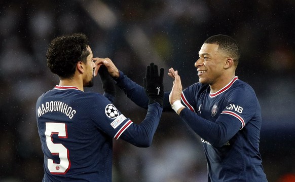 epa09760474 PSG players Marquinhos (L) and Kylian Mbappe (R) celebrate after winning the UEFA Champions League round of 16, first leg soccer match between Paris Saint-Germain (PSG) and Real Madrid in ...