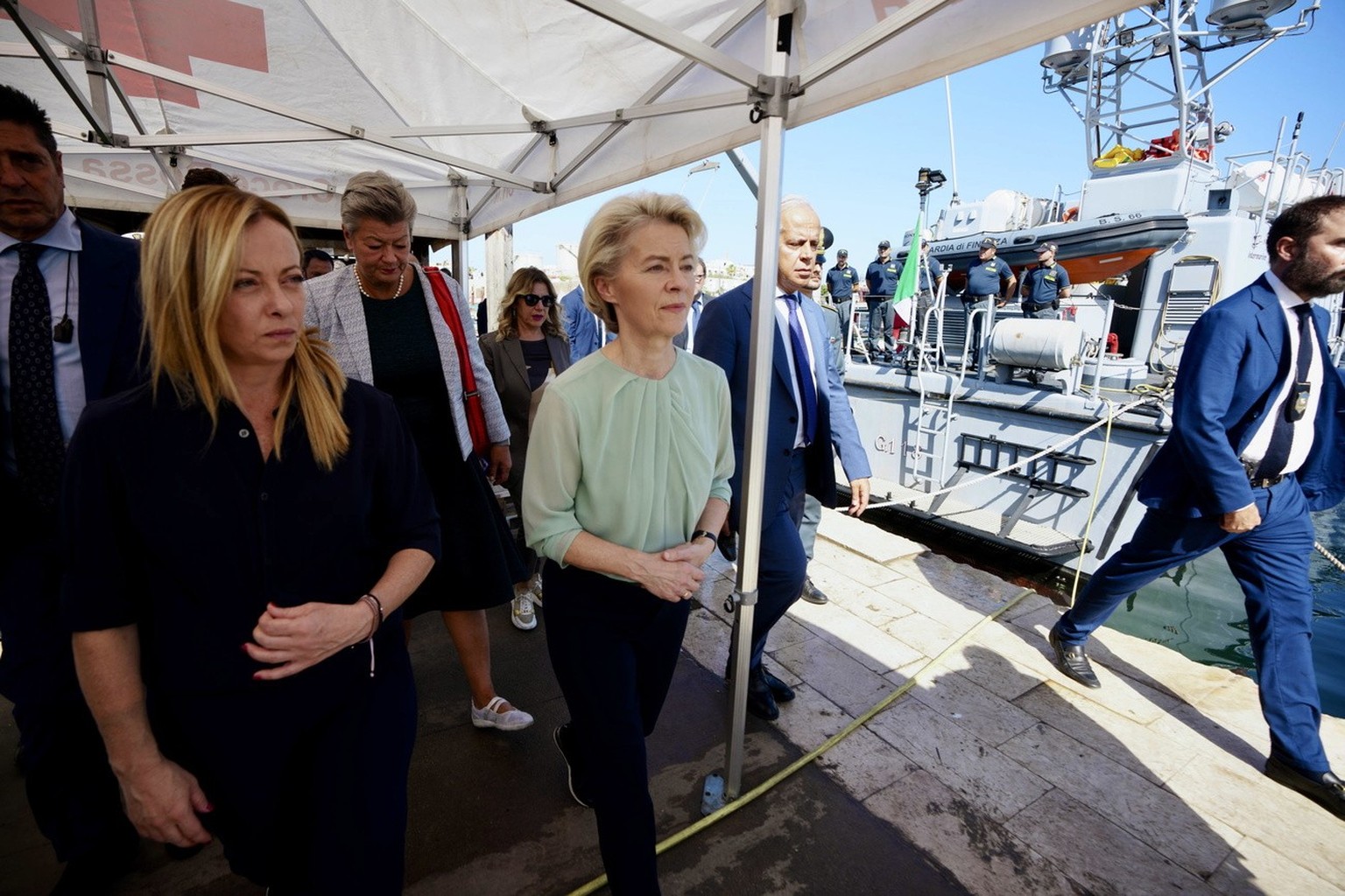 epa10865818 A handout photo made available by CHIGI PALACE PRESS OFFICE shows Italian Premier Giorgia Meloni, EU Commission President Ursula von der Leyen watch the dozens of small boats moored in fro ...