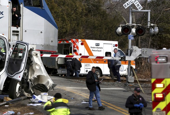 The railroad crossing arm is seen lowered next to the scene of where an Amtrak train carrying multiple Republican lawmakers crashed into a garbage truck in Crozet, Va., on Wednesday, Jan. 31, 2018. A  ...