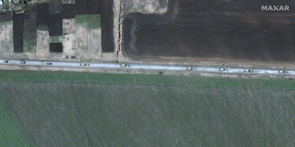 epa09881695 A handout satellite image made available by Maxar Technologies shows the northern end of a convoy of military trucks with towed artillery pieces that extends for at least eight miles movin ...