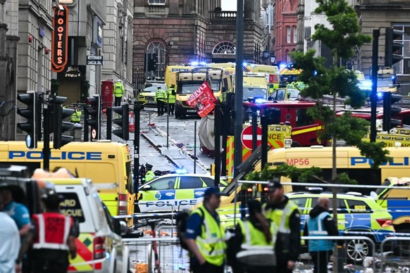 Ambulances and police vans arrive on the scene of an incident in Water Street, on the sidelines of an open-top bus victory parade for Liverpool's Premier League title win, in Liverpool, north-wes ...