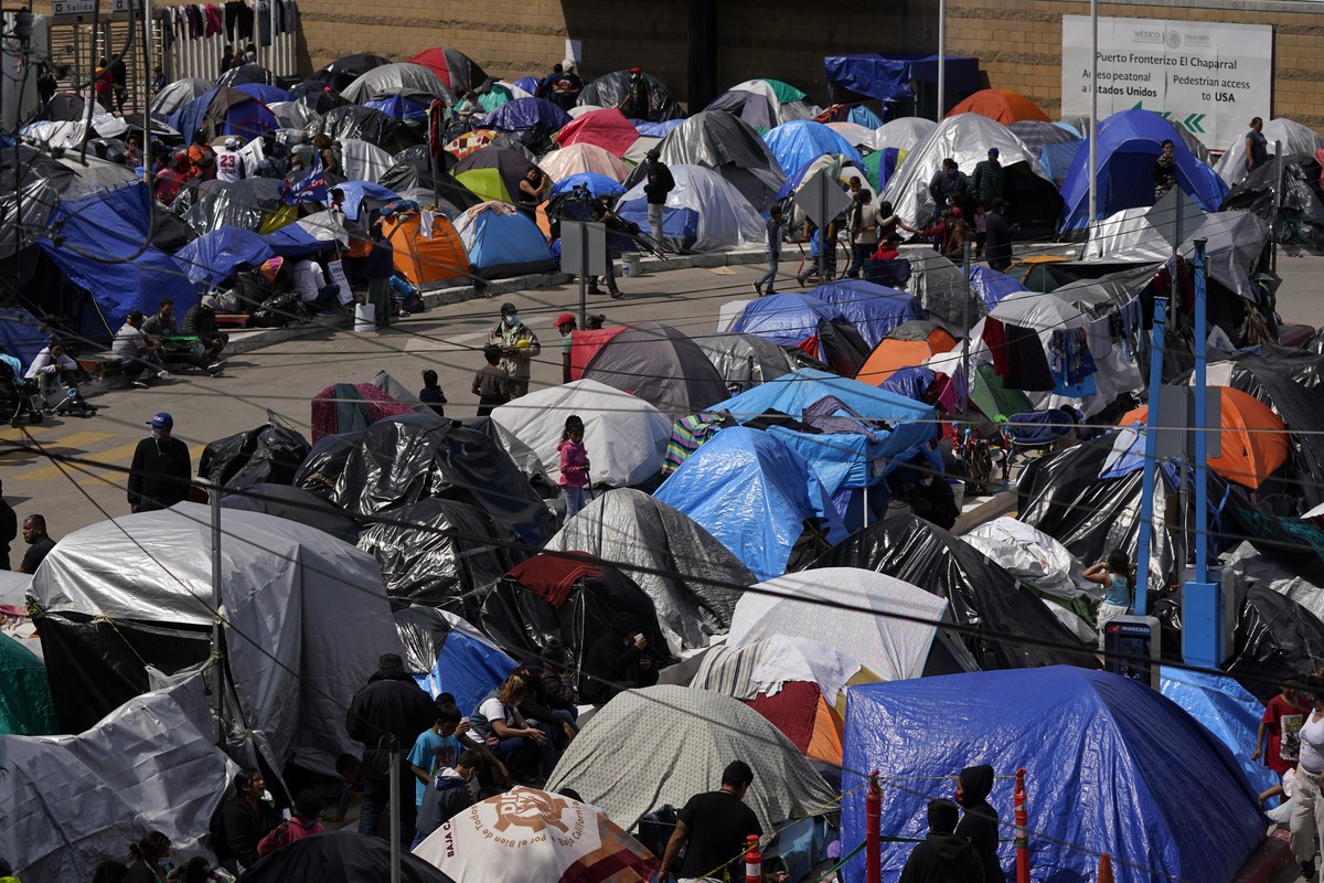 A makeshift camp of migrants sits at the border port of entry leading to the United States, Wednesday, March 17, 2021, in Tijuana, Mexico. The migrant camp shows how confusion has undercut the message ...