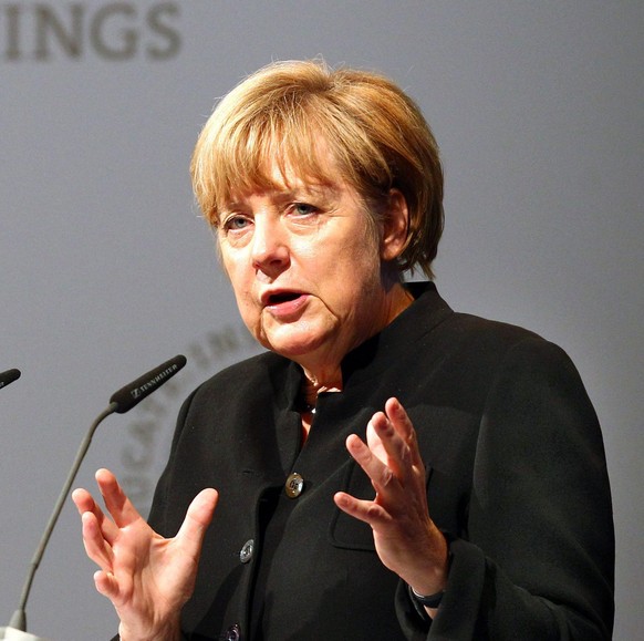 Angela Merkel epa04361227 German Chancellor Angela Merkel speaks at the opening of the 5th Lindau Meeting on Economic Sciences in Lindau, Germany, 20 August 2014. 19 Nobel Prize Laureates in Economic Sciences and 460 newcomers take part in the meeting. EPA/KARL-JOSEF HILDENBRAND