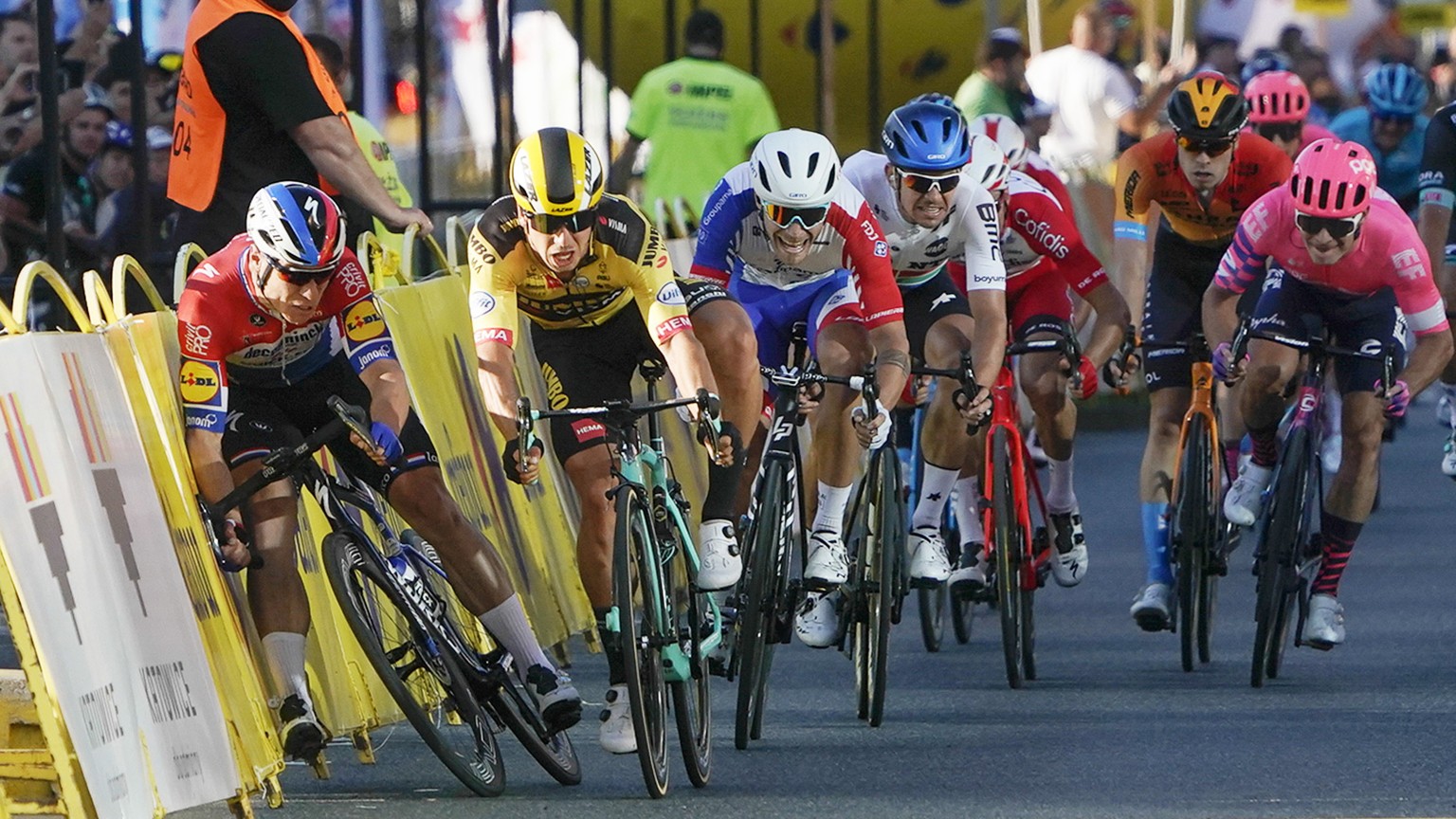 Sprinting for the win Dutch cyclist Fabio Jakobsen, left, hits side barriers at the start of a crash with his countryman Dylan Groenewegen, 2nd left, on the final stretch of the opening stage of the T ...