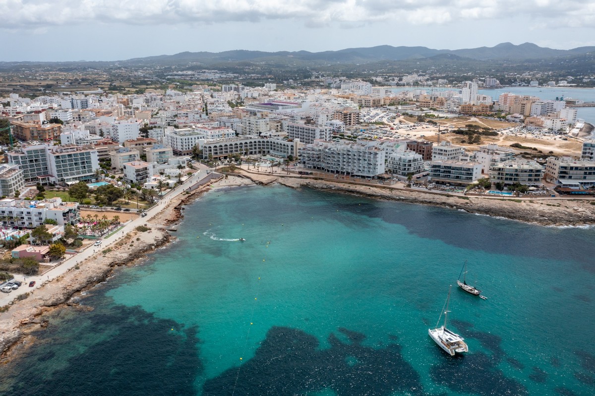 Aerial drone photo of a beach in the town of Sant Antoni de Portmany on the island of Ibiza Balearic Islands Spain showing the ocean front and Cala Alto de Porta beach in the summer time. xkwx sail bo ...