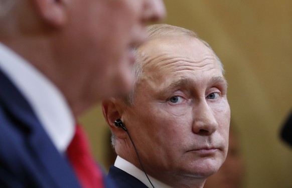 Russian President Vladimir Putin listens to U.S. President Donald Trump during a press conference after the meeting of U.S. President Donald Trump and Russian President Vladimir Putin at the President ...