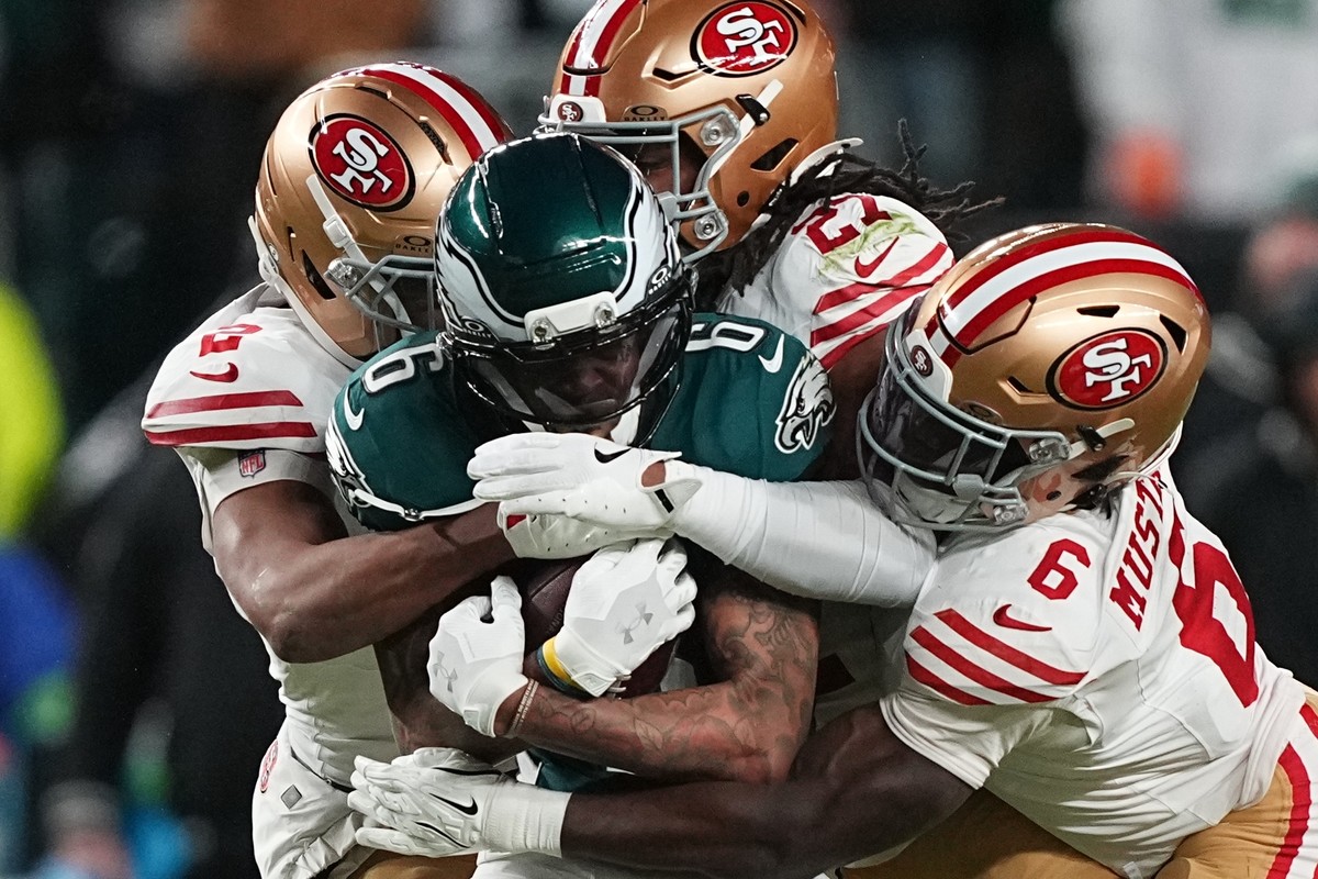 Philadelphia Eagles wide receiver DeVonta Smith (6) is stopped by San Francisco 49ers cornerback Deommodore Lenoir (2), 49ers safety Ji'ayir Brown (27) and 49ers safety Malik Mustapha (6) during  ...