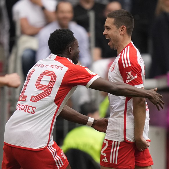 Bayern&#039;s Raphael Guerreiro, right, celebrates after scoring his side&#039;s opening goal during the German Bundesliga soccer match between Bayern Munich and Cologne at the Allianz Arena in Munich ...
