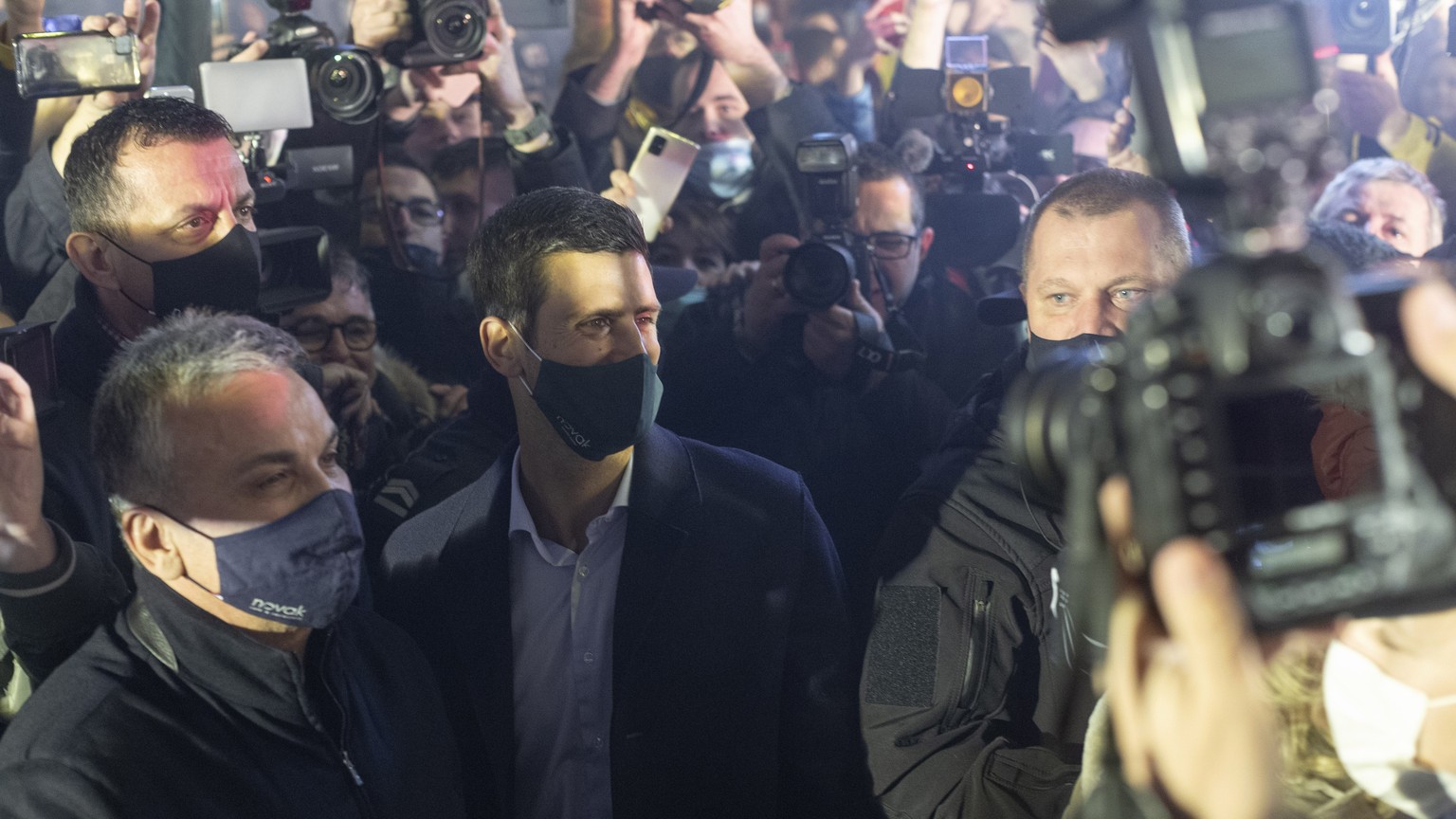 Serbian tennis player Novak Djokovic, is surrounded by fans and members of the media as he arrives at a restaurant, Belgrade, Serbia, Monday, March 8, 2021. Hundreds of Novak Djokovic supporters have  ...
