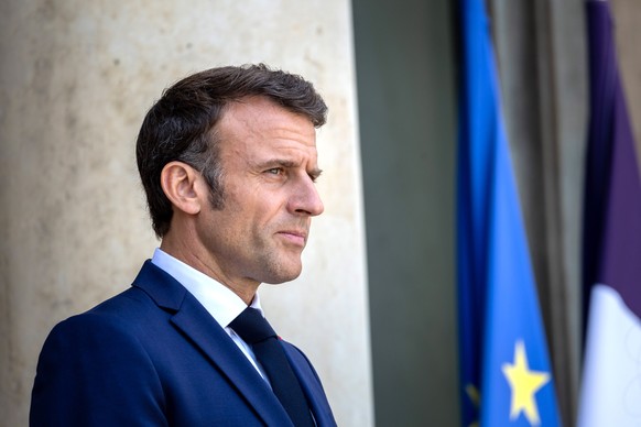 epa10707982 French President Emmanuel Macron looks on as Brazilian president arrives at the Elysee Palace for a work lunch, on the sidelines of the New Global Financial Pact Summit in Paris, France, 2 ...