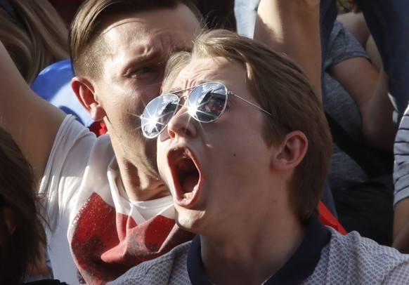 Russian fans celebrate a Russia&#039;s second goal at a fan zone during the 2018 soccer World Cup match between Russia and Saudi Arabia in St.Petersburg, Russia, Thursday, June 14, 2018. (AP Photo/Dmi ...