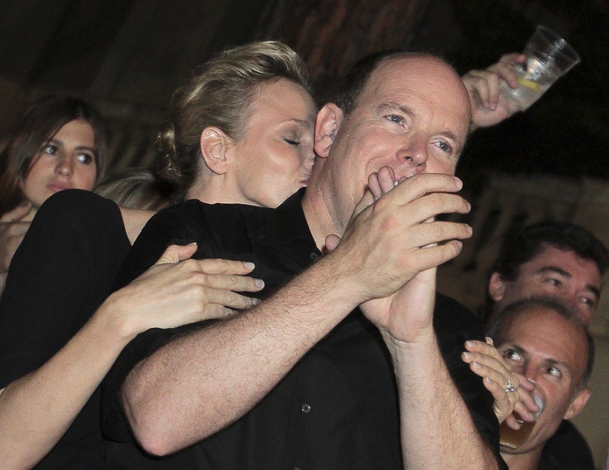 Prince Albert II of Monaco and his fiancee Charlene Wittstock dance during the open-air concert of American blues rock trio, ZZ Top and American singer Iggy Pop, in front of The Prince's Palace o ...