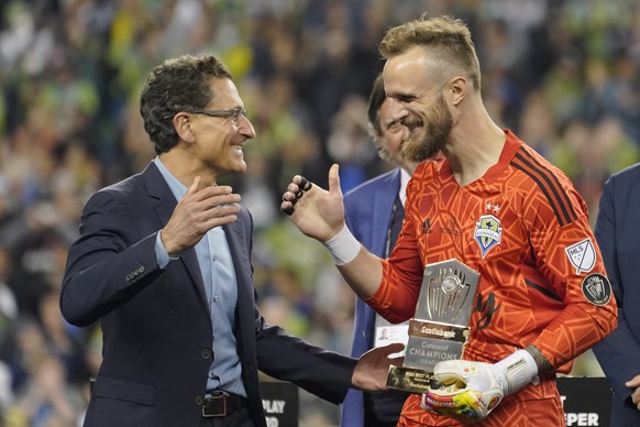 United States&#039; Seattle Sounders goalkeeper Stefan Frei, right, celebrates with Sounders team owner Adrian Hanauer after the Sounders defeated Mexico&#039;s Pumas to win the CONCACAF Champions Lea ...