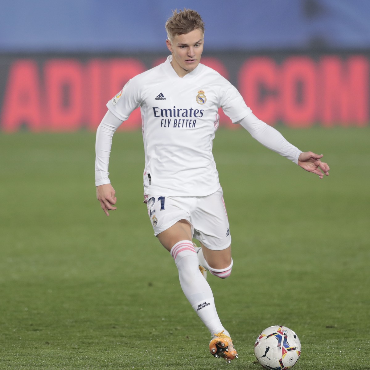 Real Madrid's Martin Odegaard runs with the ball during the Spanish La Liga soccer match between Real Madrid and Alaves at Alfredo di Stefano stadium in Madrid, Spain, Saturday, Nov. 28, 2020. (A ...