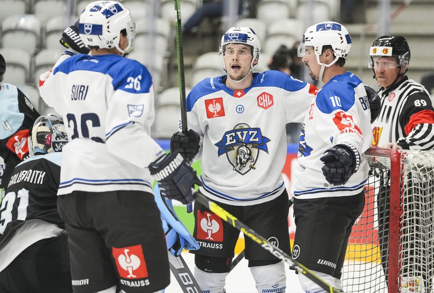 epa09434316 Zug players cheer after scoring, from left Reto Suri (EV ZUG 26), Luca Hollenstein (EV ZUG 51) and Jer, during the Champions League Hockey match SonderjyskE vs EV Zug in Vojens, Denmark, 2 ...