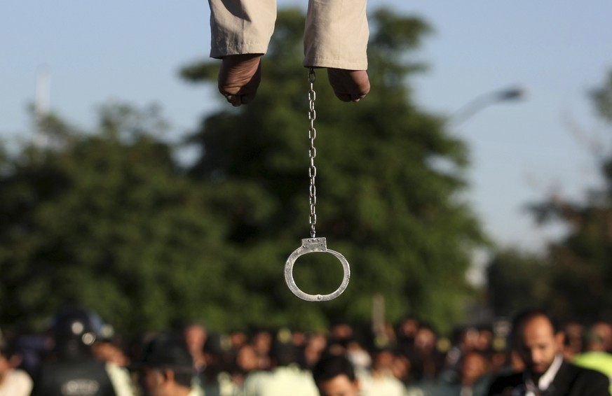 FILE - In this May 26, 2011 file photo, the feet of convicted man Mahdi Faraji, is seen with shackle, while he is being hanged, at the city of Qazvin about 80 miles (130 kilometers) west of the capita ...