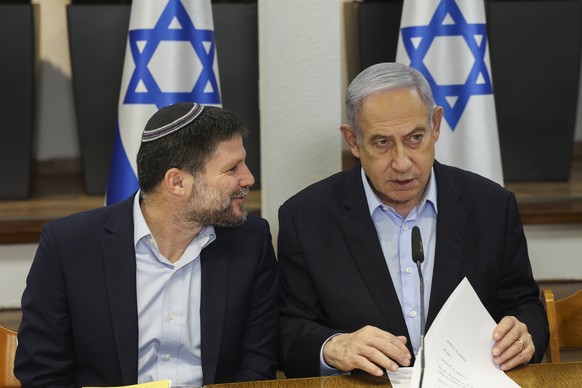 Israeli Prime Minister Benjamin Netanyahu, right, speaks with Minister of Finance Bezalel Smotrich during the weekly cabinet meeting at the Defence Ministry in Tel Aviv, Israel, Sunday Jan. 7, 2024. ( ...