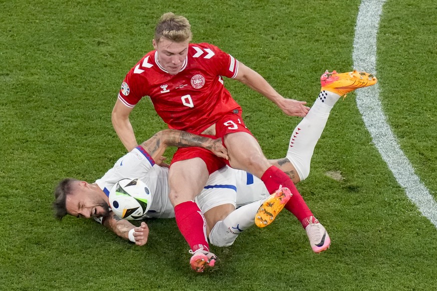 Denmark&#039;s Rasmus Hojlund, right, and Serbia&#039;s Nemanja Gudelj challenge for the ball during a Group C match between the Denmark and Serbia at the Euro 2024 soccer tournament in Munich, German ...
